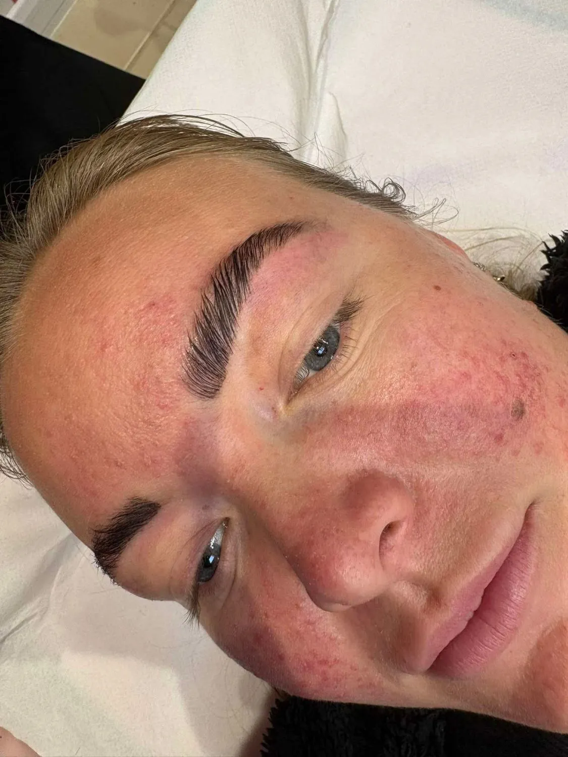 Close-up of laminated brows with a soft, brushed-up finish